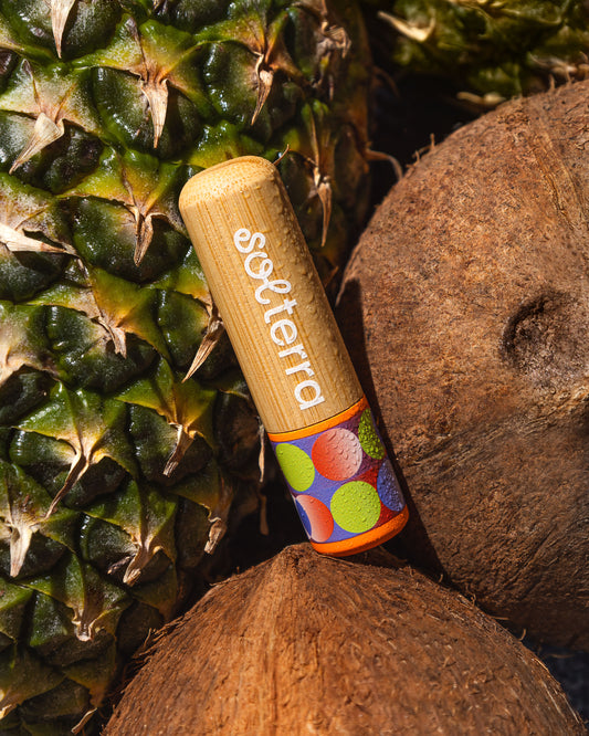 Wooden product with 'solterra' branding on a background of a pineapple and coconut.