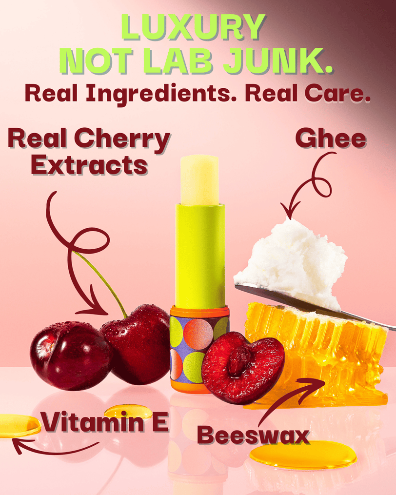 Lip balm with cherry extract, ghee, vitamin E, and beeswax on a pink background.